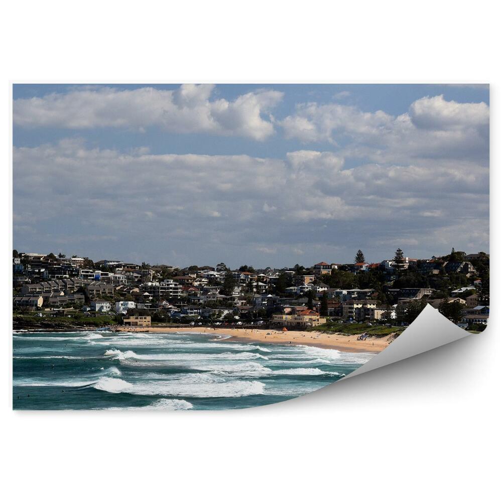 Fototapeta Budynki ocean fale plaża niebo chmury